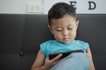 little boy sitting on a chair