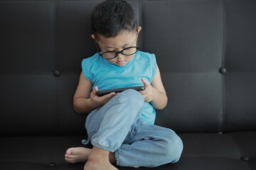 little boy sitting on a chair