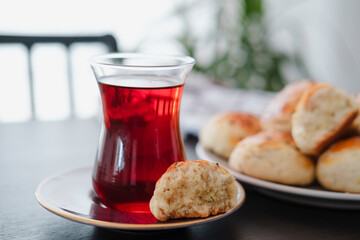 homemade turkish savory pastry pogaca with dill and black sesame or cumin, served with tea for breakfast or noon break