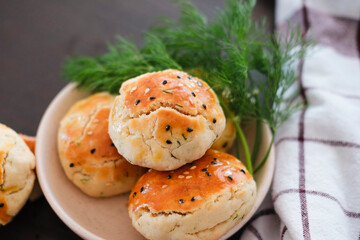 turkish savory pastry pogaca with dill and black sesame or cumin, homemade quick snack