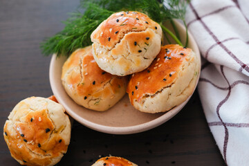 turkish savory pastry pogaca with dill and black sesame or cumin, homemade quick snack