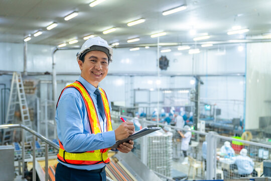 Canned food manufacturing business industry. Businessman factory manager inspect processed food production in plant room. Male engineer maintenance automated conveyor belt system in production line.