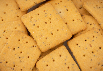 Whole grain crackers with flax and sesame seeds isolated on white background. Dry salted cracker cookies. Snack. Gluten free crackers