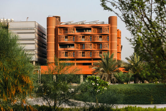 The Masdar Institute of Science and Technology exterior with green garden on the foreground. Sustainable environment.
