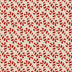 Seamless festive pattern with red and white candy canes on a beige background. Christmas holiday sweet design for wrapping paper, textiles, and festive decor.