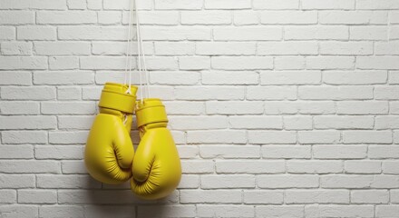 Hanging Yellow Boxing Gloves Trainings Bright Start On White Brick Wall.