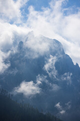 The mountains shrouded in clouds seen from San Martino di Castrozza - Italy