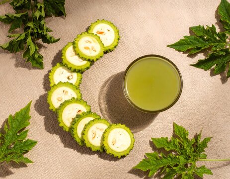 Pointed Gourd Slices Arranged with Leaves and Green Juice