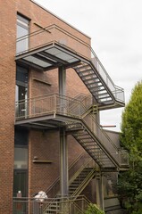 Metal fire escape leading down from brick building