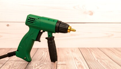 Green cordless drill on wood