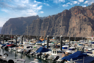 Spain, Los Gigantes - 28.03.2025: Panoramic view of huge cliffs of Los Gigantes and marina in seaside town Los Gigantes in Tenerife, Canary Islands, Spain.