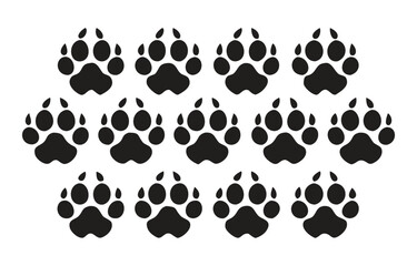 Set of twelve black dog paw prints with white outline great for pet themed designs and animal graphics