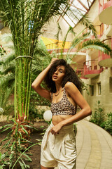 Vibrant fashion moment in a tropical paradise with stylish animal print ensemble