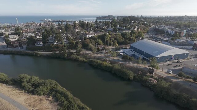 RAW Aerial of San Lorenzo River & Riverside Ave Bridge to Monterey Bay &mdash; Santa Cruz Boardwalk Neighborhoods, Wharf and Coastline Cityscape (California, USA) &ndash; Ungraded LOG/DLOG Drone Footage
