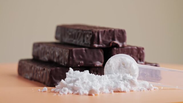 Vanilla protein powder in scoop and protein bars. Dietary supplement, nutrition, healthy energy snack. Food supplements