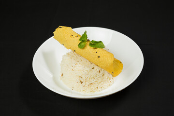 Traditional Indian Jeera Rice served with Papad in plate isolated on dark background side view a Classic Meal