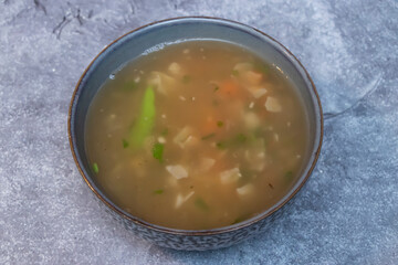 Delicious Vegetable Clear Soup in a Bowl side view of Healthy and Light Meal