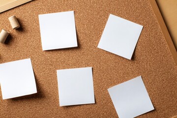 Empty white sticky notes arranged in two rows of three on a cork bulletin board, ideal for planning, reminders, or presentations.
