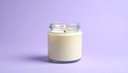 A candle in glass jar isolated on a plain purple background
