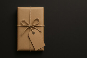 Wrapped gift with blank tag on a dark background, elegant and simple presentation for any occasion