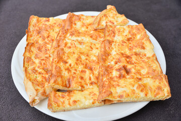 Turkish pide with pieces of cheddar 
