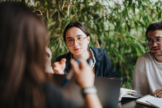 Group of high school friends collaborating on assignments in a warm coffee shop environment, fostering creativity and teamwork. The scene evokes feelings of learning and camaraderie.