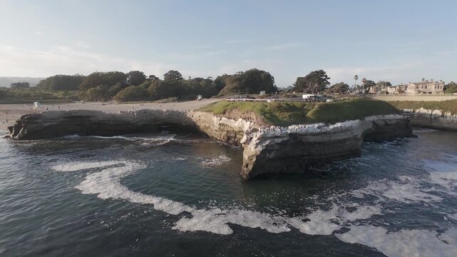 Santa Cruz California Coastal Cliffs & Beach Cove at Golden Hour &mdash; RAW Aerial Drone Footage in LOG/DLOG/DNG, Ungraded Ocean Waves, Surfers & Rocky Shoreline for Color Grading and Travel Stock