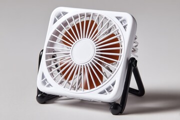 Small, square, white fan on stand
