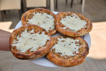 Turkish pide with pieces of cheddar 

