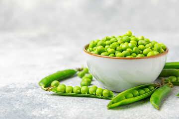 Fresh green pea pods with green peas on a wooden background. Sweet green peas. Green pea beans vegetables. Vegan. healthy vegetable. Copy space