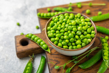 Fresh green pea pods with green peas on a wooden background. Sweet green peas. Green pea beans vegetables. Vegan. healthy vegetable. Copy space