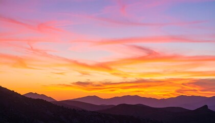 Sunset over mountain range, vibrant colors