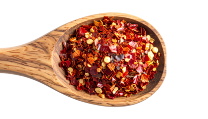 Spicy chili red pepper flakes, chopped, milled dry paprika pile in wooden sppon isolated on white, top view