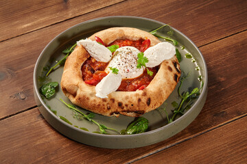 Delicious italian style pizza with egg, tomato sauce, and cheese on wooden table