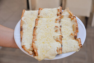 Turkish pide with pieces of cheddar 
