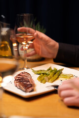 Glass of wine served with gourmet steak and vegetables