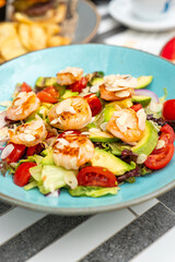 Fresh shrimp and avocado salad on blue plate