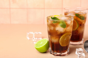 Glasses of cold Cuba Libre cocktail on table
