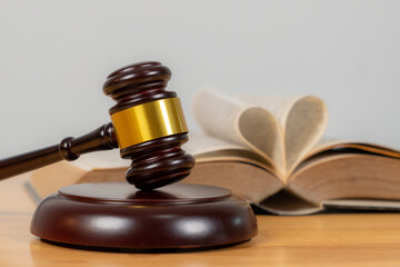 Close-up of a gavel with a judge in the background, symbolizing law, legal proceedings, justice, and courtroom authority