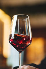 Fine dining scene with red wine being poured into glass