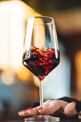 Romantic dinner with glass of red wine and soft lights