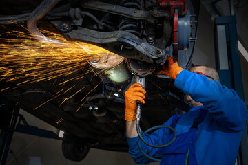 Auto Mechanic Grinding a Metal Piece with Sparks in Repair Shop