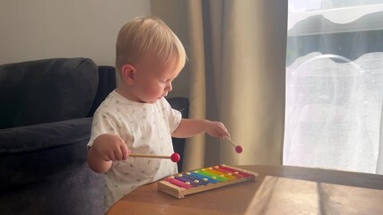 Little boy playing xylophone. Child and musical instruments, art in play, early childhood development - Powered by Adobe