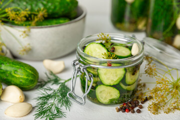 Freshly-salted homemade cucumbers in a jar on a wooden background. pickled cucumbers with dill,garlic and pepper.canned cucumbers.cucumbers and dill.Recipe of homemade preservations.fermented veggies.