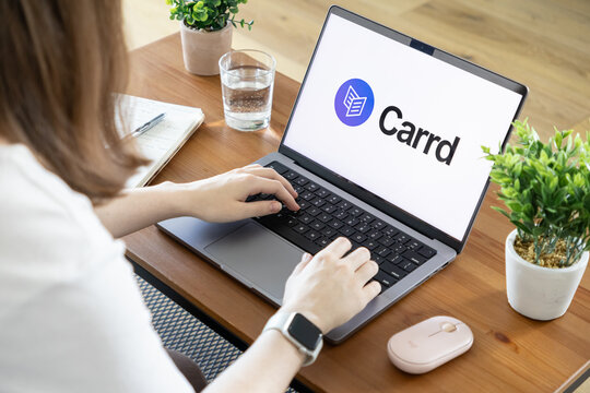 Poznan, Poland - August 23, 2025: Carrd application shown on a modern laptop, a person typing, efficiently representing online business creation and agile remote work solutions