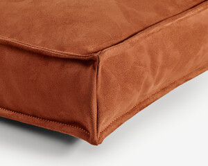 Close-up of corner of modern suede cushion showing stitching detail