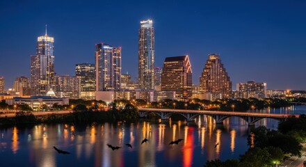 Night panorama of Austin city skyline with flying bats reflecting in river