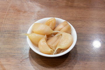 Pickled garlic in a small bowl