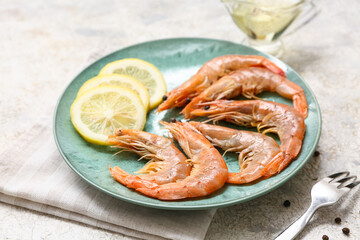 Plate with tasty boiled shrimps, lemon and peppercorn on grey background
