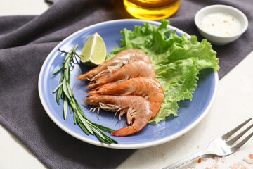 Plate with tasty boiled shrimps lettuce, lime and rosemary on white background